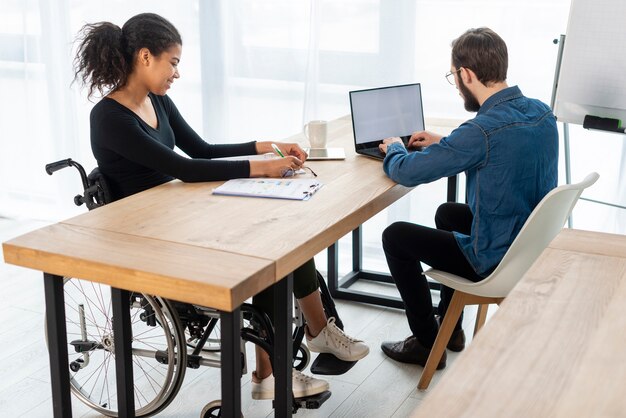 Adult man and woman working together at the office