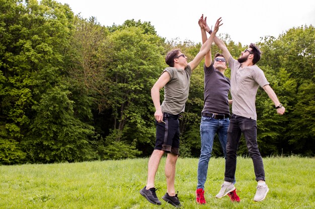 Adult men jumping and giving high five