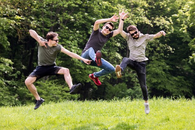 Adult men posing and jumping in mid air