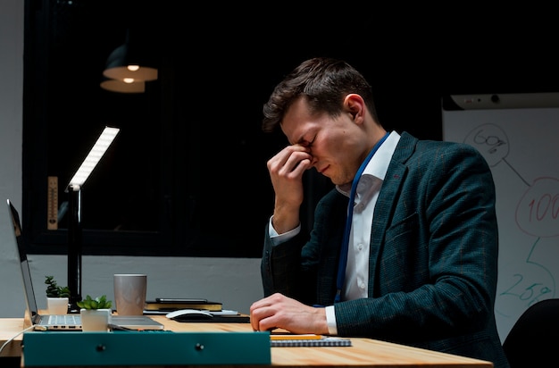 Adult professional tired after working at night