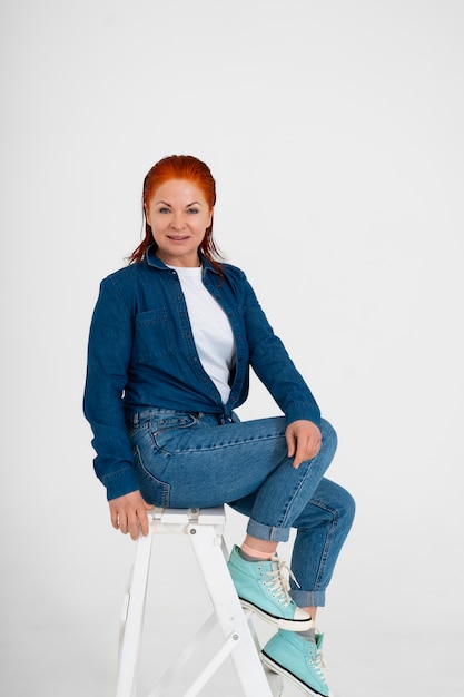 Free photo adult red-haired woman wearing denim outfit