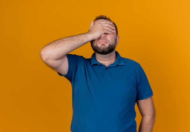 Adult slavic man putting hand on eyes 