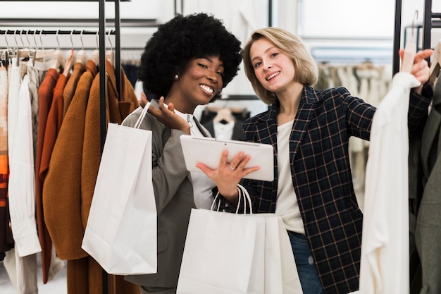 Adult smiley women shopping together