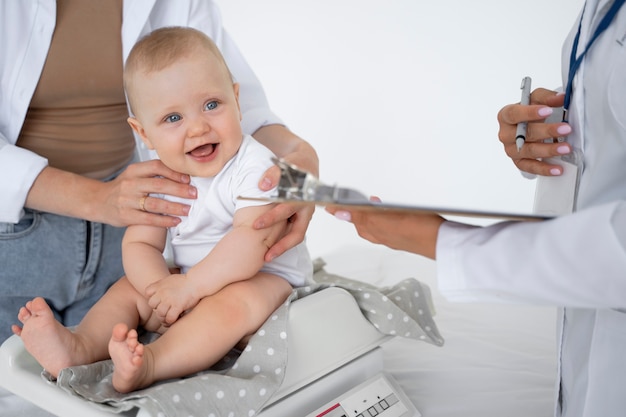 Free photo adult taking care of baby weight