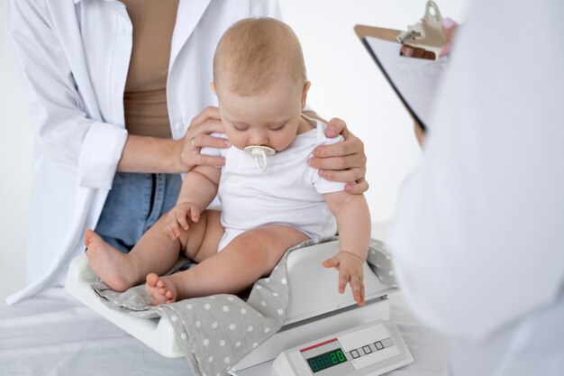 adult taking care of baby weight
