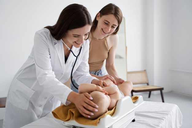 Free photo adult taking care of baby weight