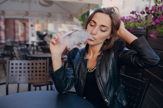 Free photo adult touching her head while smoking
