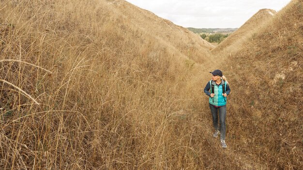 Adult traveler hiking on a path