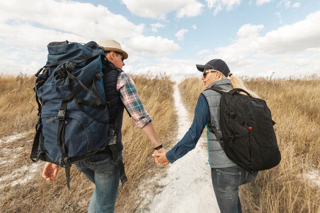 Adult travelers holding hands outdoors