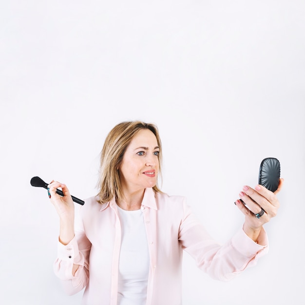 Adult woman applying makeup