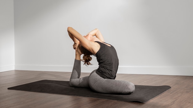 Adult woman doing yoga at home