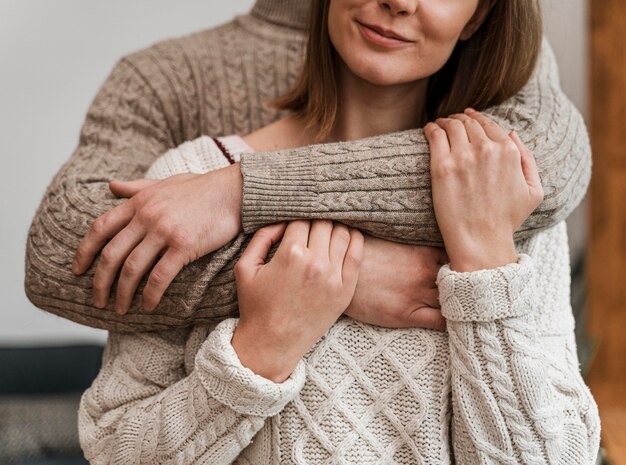 Adult woman hugging her husband