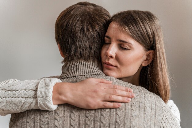 Adult woman hugging her husband