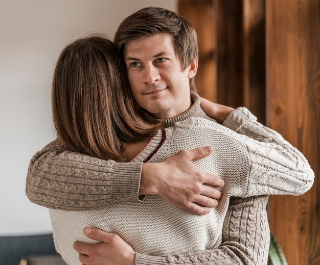 Adult woman hugging her husband