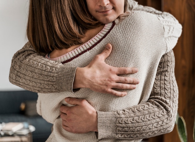 Adult woman hugging her husband