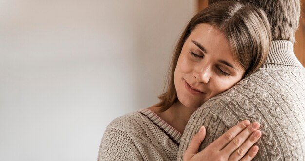 Adult woman hugging her husband