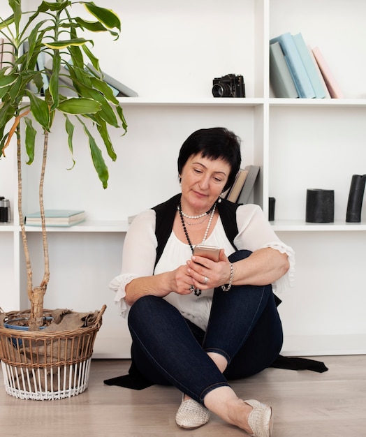 Free photo adult woman looking at her phone