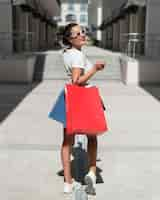 Free photo adult woman posing with shopping bags