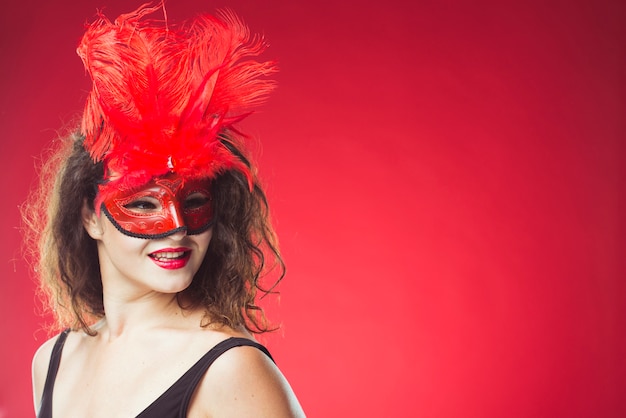 Adult woman in red carnival mask