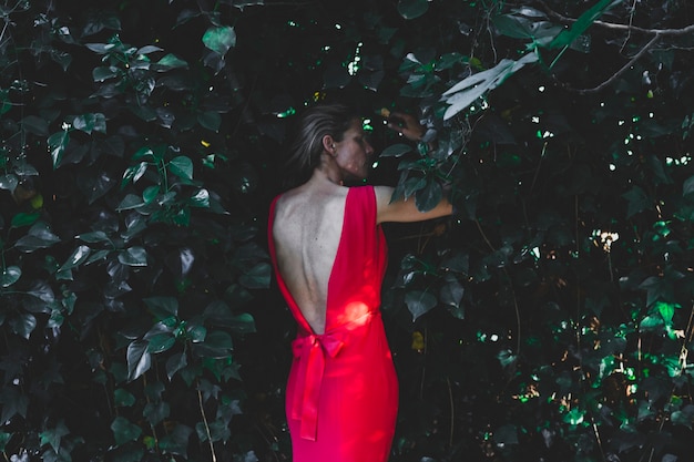 Adult woman standing in bushes