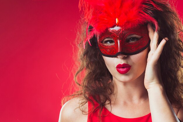 Adult woman standing in red mask