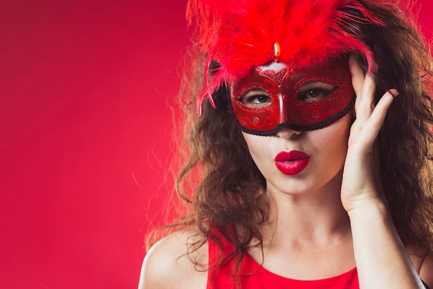 Adult woman standing in red mask