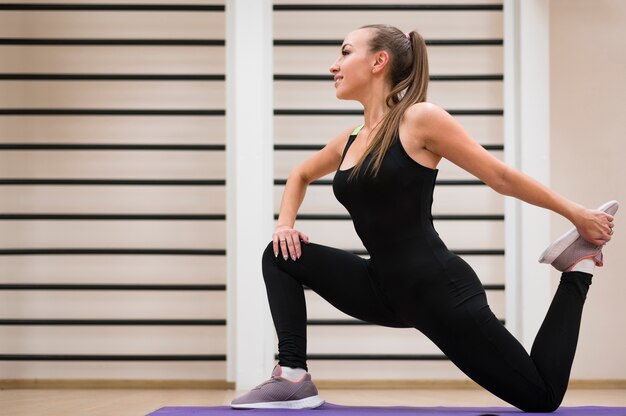 Adult woman stretching at the gym