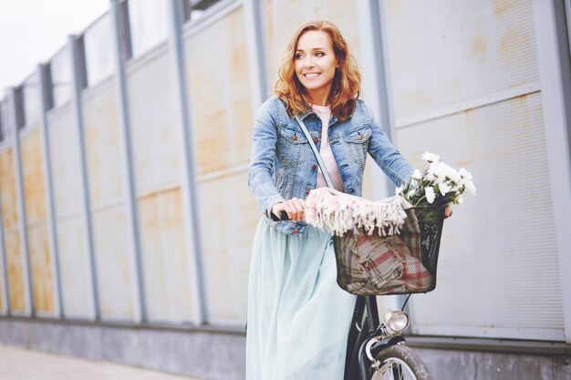 Adult woman with bike in the city