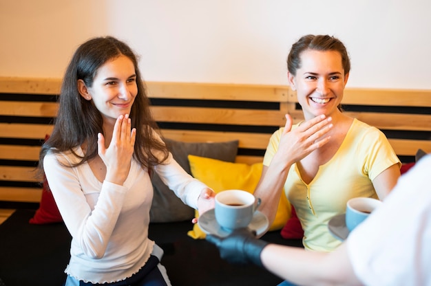 Adult women communicating through sign language