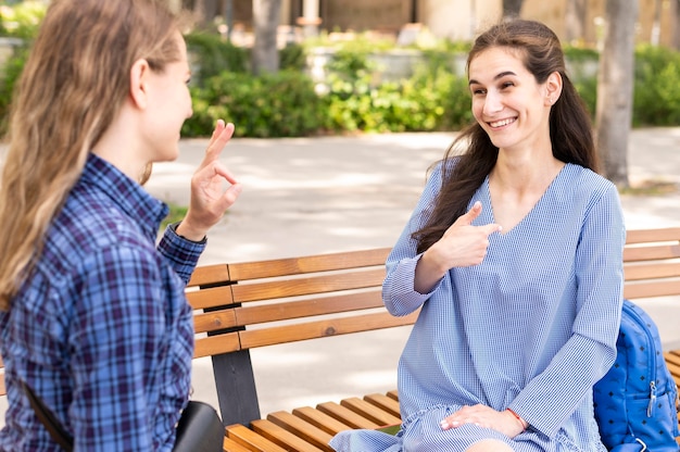 Adult women communicating through sign language