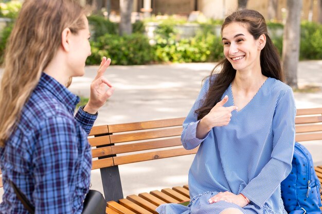 Adult women communicating through sign language