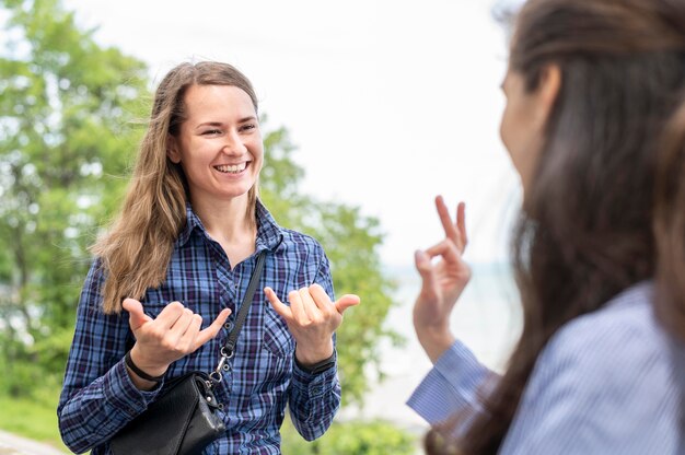 Adult women communicating through sign language