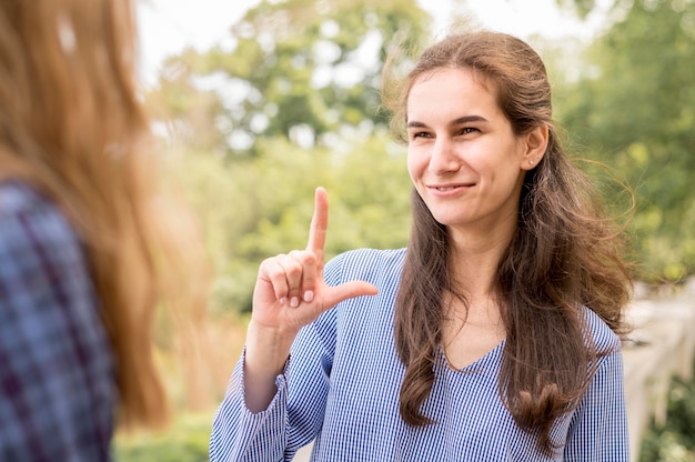 Foto gratuita donne adulte che comunicano attraverso il linguaggio dei segni