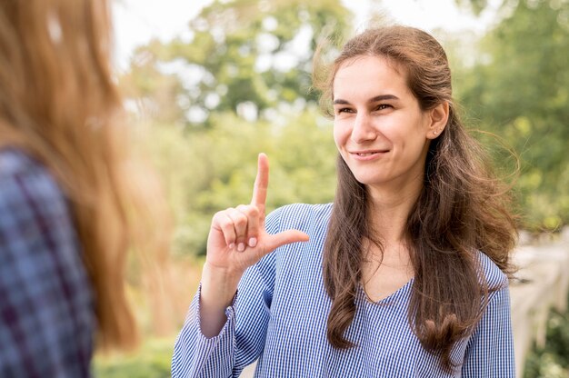Adult women communicating through sign language