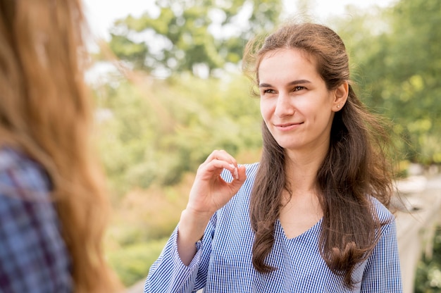 Adult women communicating through sign language