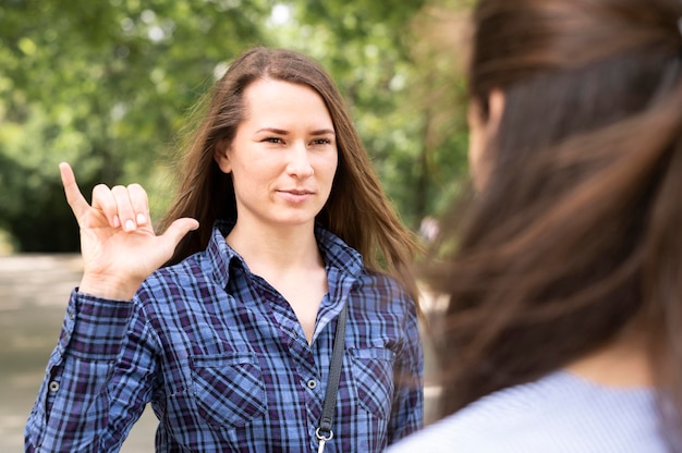 Adult women communicating through sign language