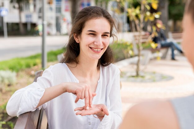 Adult women communicating through sign language