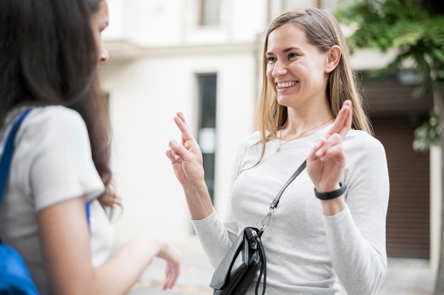 Adult women communicating through sign language