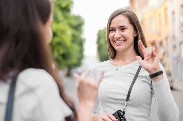 Adult women communicating through sign language