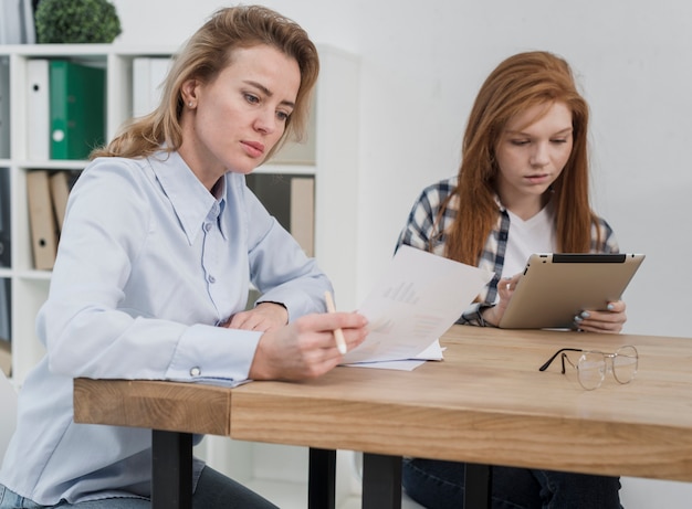 Adult and young women working together