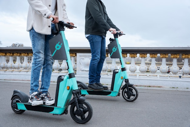 Adults learning to use electric scooter