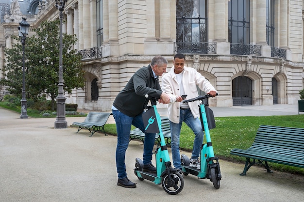 Adults learning to use electric scooter