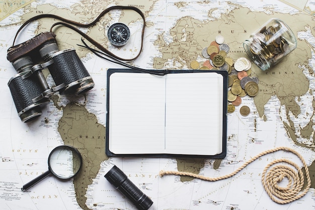 Free photo adventure composition with world map and open notebook