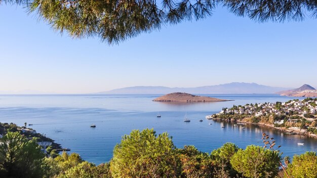 Aegean coast with marvelous blue water, rich nature, islands, mountains and small white houses