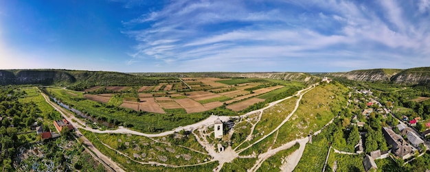 Aerial drone panoramic view of nature church valley with river and hills