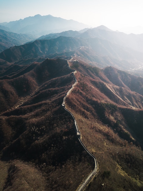 Aerial drone photography of the Great Wall of China with sunlight shining on the side