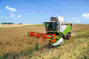 Free photo aerial drone view of the harvester gathering crops