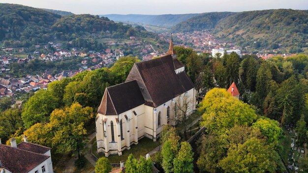 Aerial drone view of the Historic Centre of Sighisoara Romania Church on the Hill surrounded