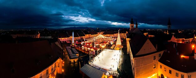 Aerial drone wide view of The Big Square in Sibiu at night Romania Old city centre decorated