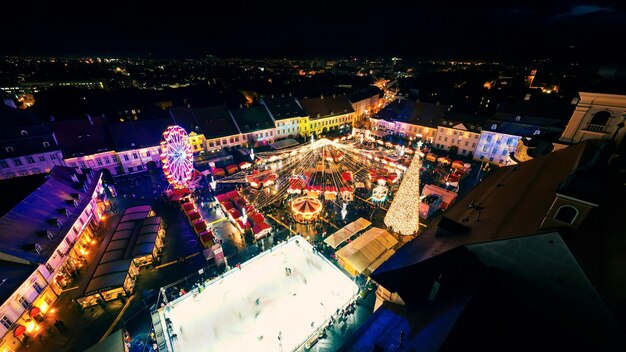 Aerial drone wide view of The Big Square in Sibiu at night Romania Old city centre decorated